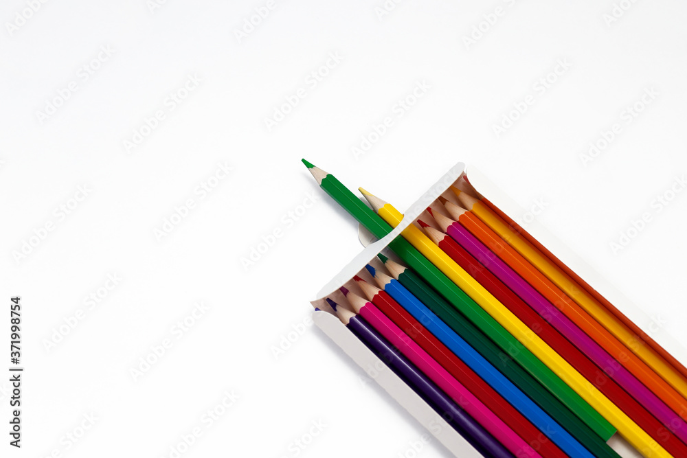 Colored pencils in a box isolated on a white background.
