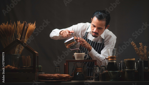 Male barista pours boiling ...