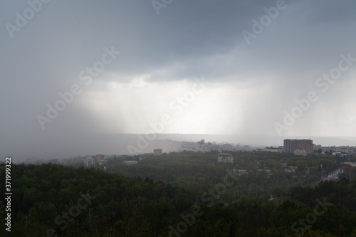 Dark cloud pouring rain over the city