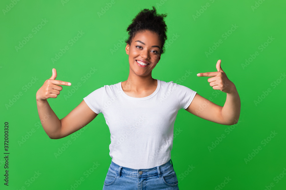 Happy young woman pointing fingers at herself Happy young woman pointing fingers at herself