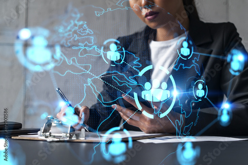 Businesswoman taking notes and social media icons hologram. Double exposure. Technology security network solution concept.