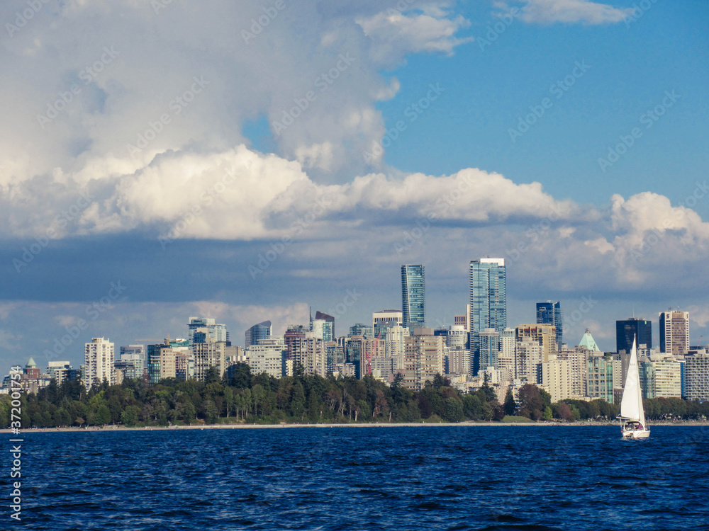 Sailboat and Vancouver skyline seen from the sea on a beautiful summer day.