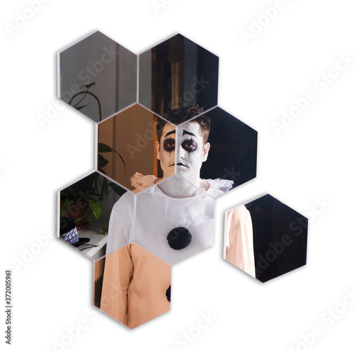 a man in a piero suit looks in the mirror at the halloween party. Happy Halloween. depression. psychology
