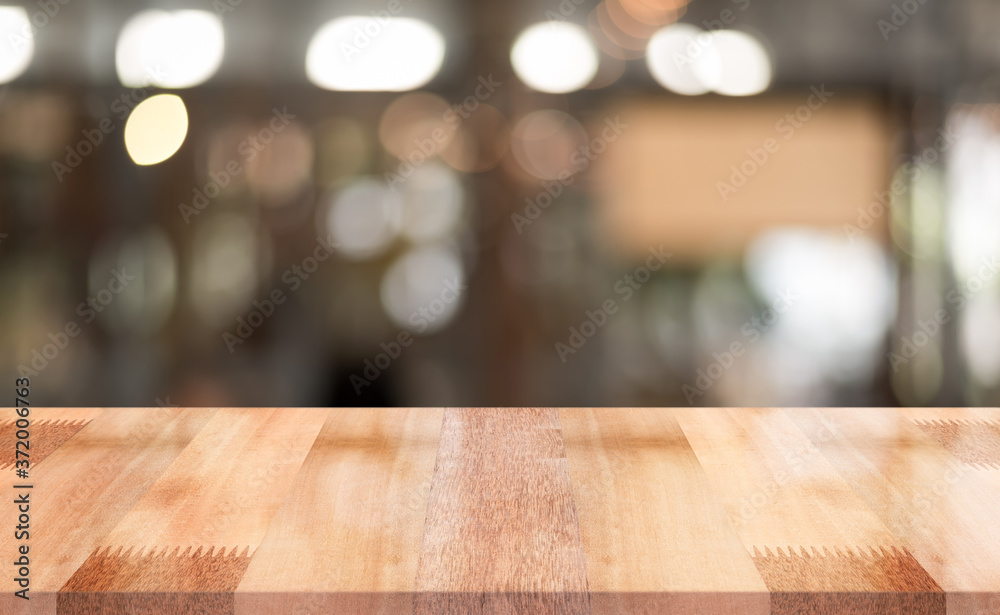 Empty wooden table top with lights bokeh on blur restaurant background Empty wooden table top with lights bokeh on blur restaurant background