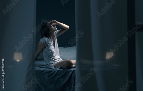 Photography Tired sleepless woman suffering from the heat in bed