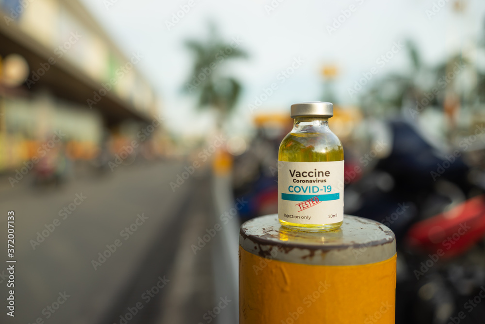 A single bottle vial of Covid-19 coronavirus vaccine in public. The coronavirus is expected to end. Hope, healthcare, medical concept. A single bottle vial of Covid-19 coronavirus vaccine in public. The coronavirus is expected to end. Hope, healthcare, medical concept.