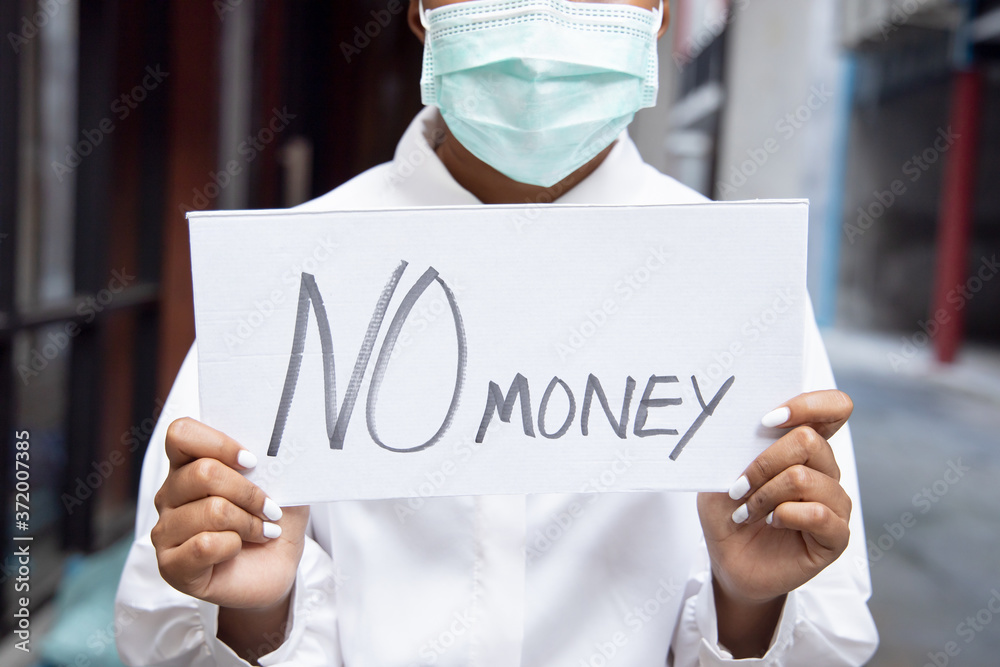 African woman wearing face mask, having no money due to job cut, employment disruption after COVID-19 pandemic led economic recession African woman wearing face mask, having no money due to job cut, employment disruption after COVID-19 pandemic led economic recession