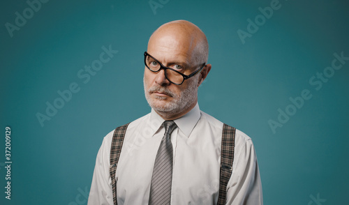 Frustrated serious businessman with crooked glasses