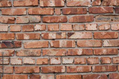 Wall of red bricks. Texture or background of bricks.