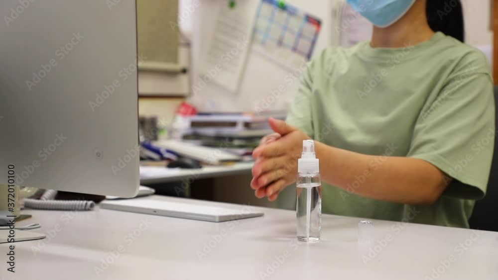 office lady with face masks washing hands using alcohol gel or antibacterial soap sanitizer before working to prevent the spread of germs and bacteria and avoid infections corona virus office lady with face masks washing hands using alcohol gel or antibacterial soap sanitizer before working to prevent the spread of germs and bacteria and avoid infections corona virus