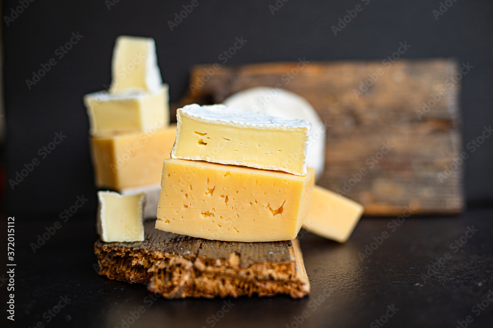 cheese assortment of different types of hard and soft cheeses serving