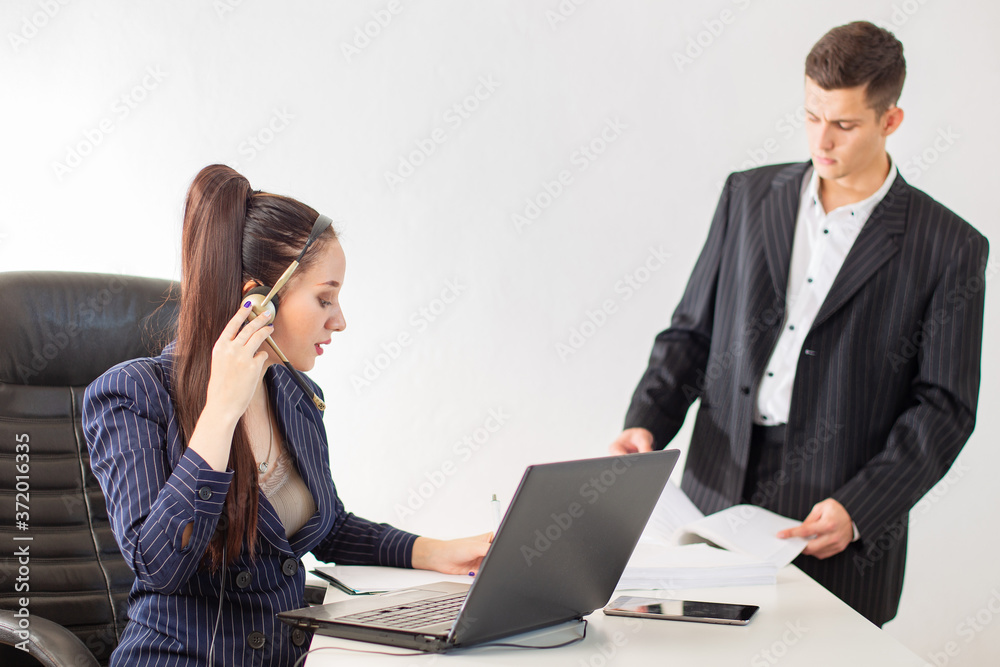 A man and a woman in business suits. Office work. Colleagues do their job. Employees don't pay attention to each other. Teamwork. A man and a woman in business suits. Office work. Colleagues do their job. Employees don't pay attention to each other. Teamwork.