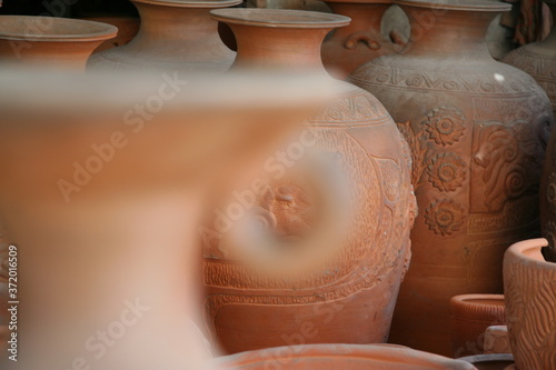 Thai earthenware handmade carved pots arranged in a pattern of Thai art photo