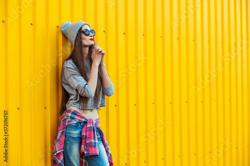 Beautiful Trendy teen Girl over Yellow Wall © Inna Vlasova