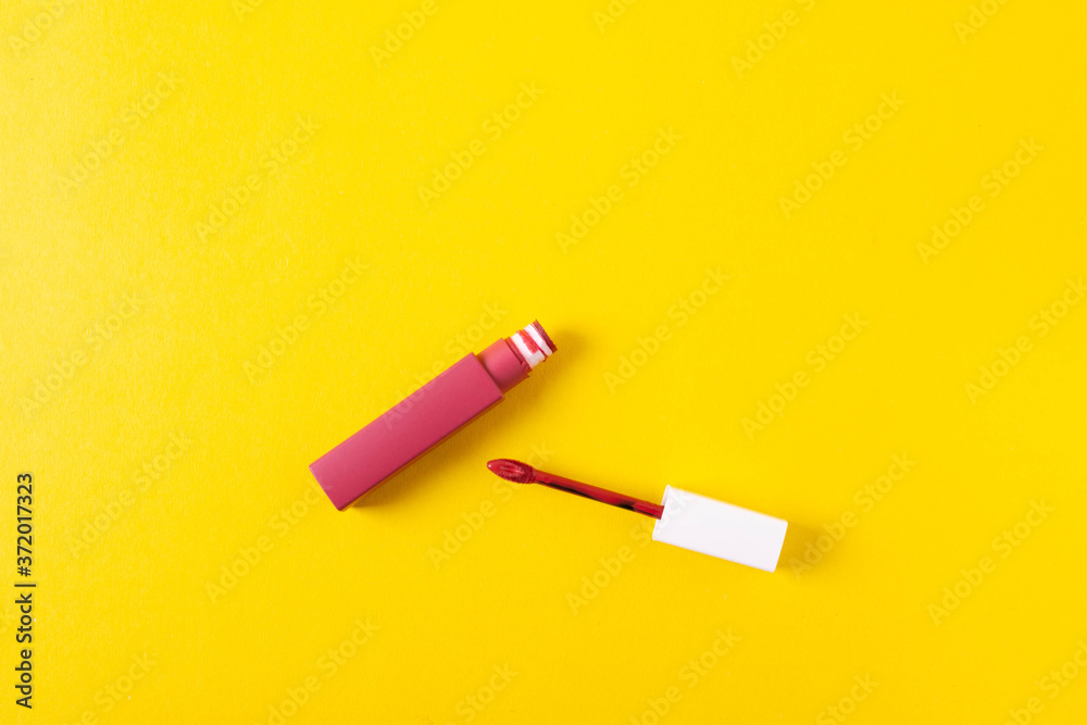 female bright lipsticks on mono colour yellow background female bright lipsticks on mono colour yellow background