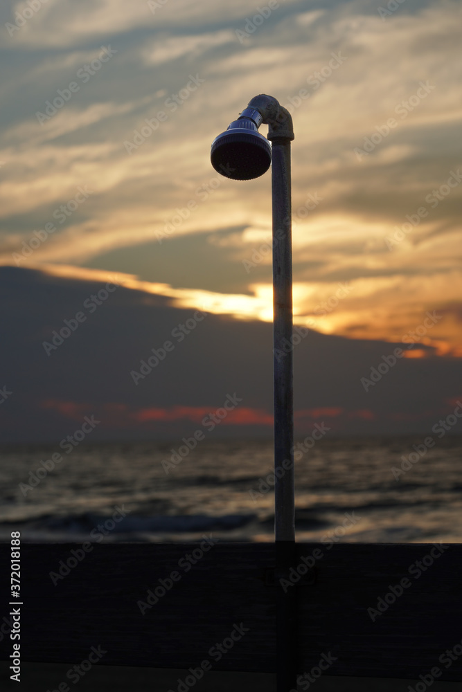 Outdoor shower for beach goers during sunrise