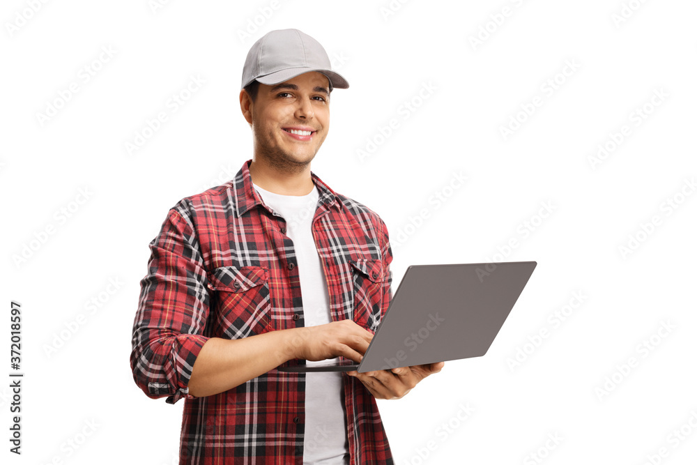 Young man with a cap holding a laptop computer and smiling at the camera Young man with a cap holding a laptop computer and smiling at the camera