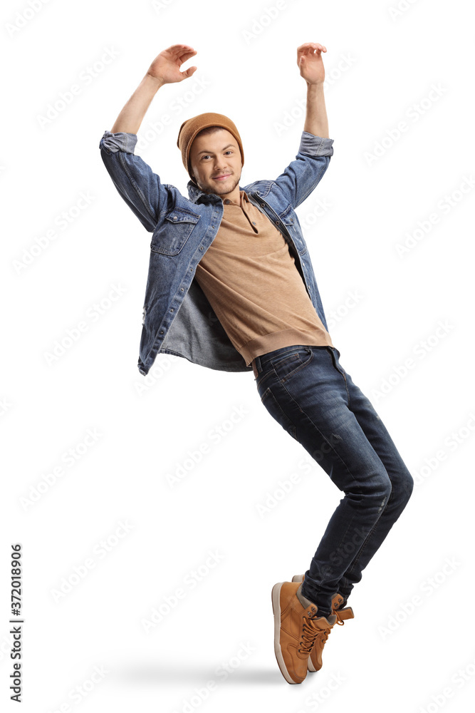 Guy in casual wear dancing and raising hands up