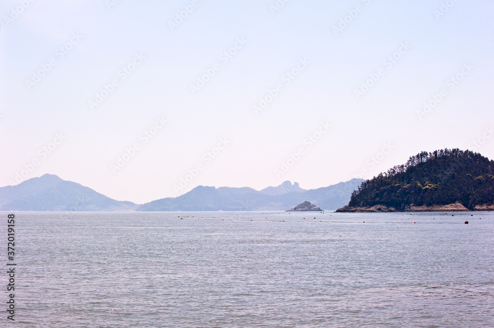 Misty island,mysterious seascape in light fog.