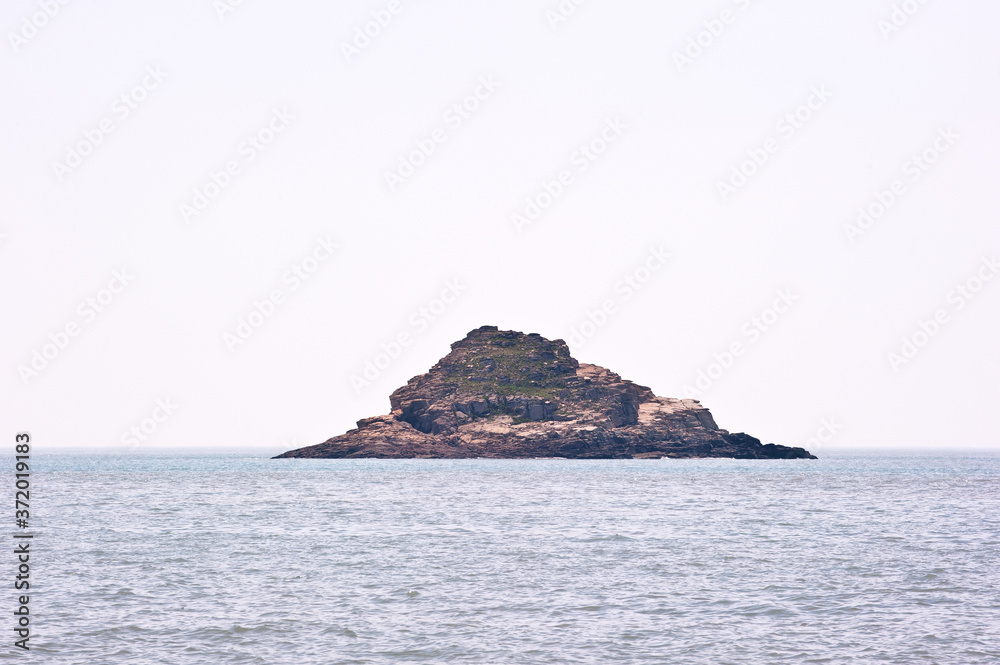 Misty island,mysterious seascape in light fog. Misty island,mysterious seascape in light fog.