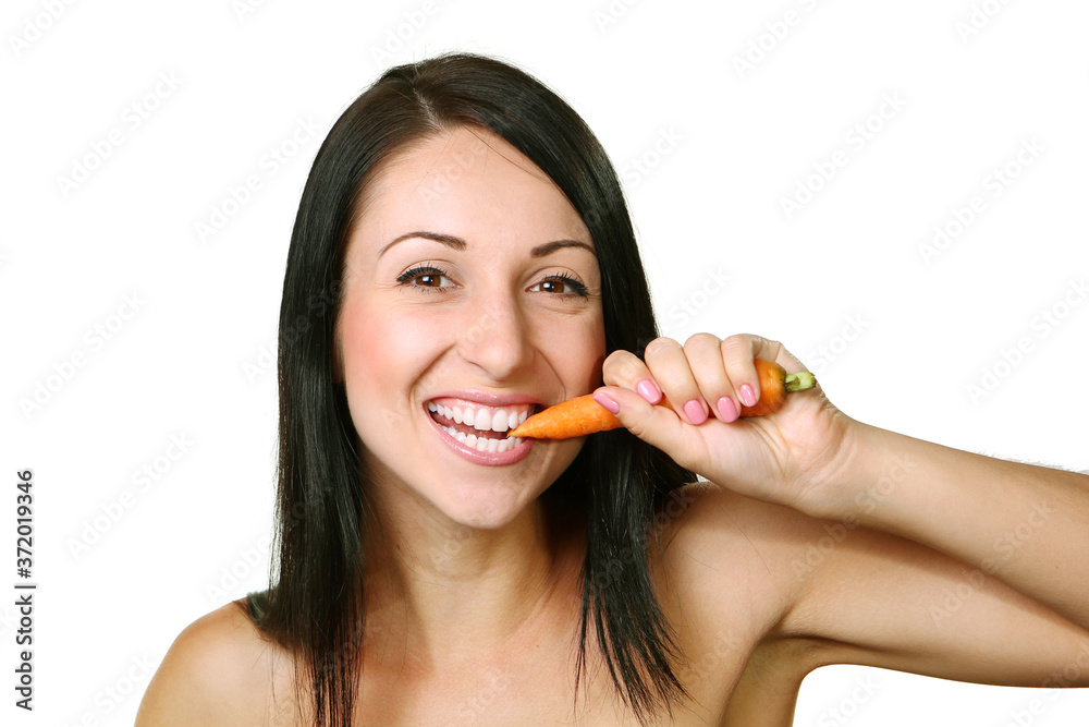 young woman eating the carrot, over white background young woman eating the carrot, over white background