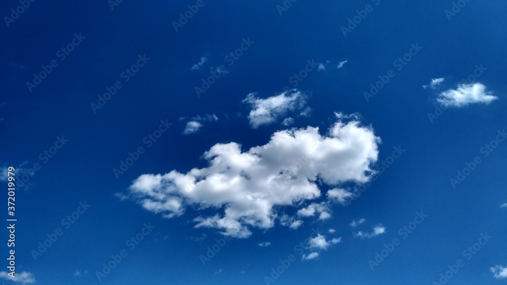 Blue sky with white clouds. Peaceful sky background. Space for text. Blue sky with white clouds. Peaceful sky background. Space for text.