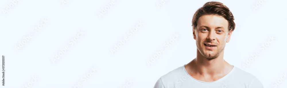 Panoramic shot of young man looking at camera isolated on white