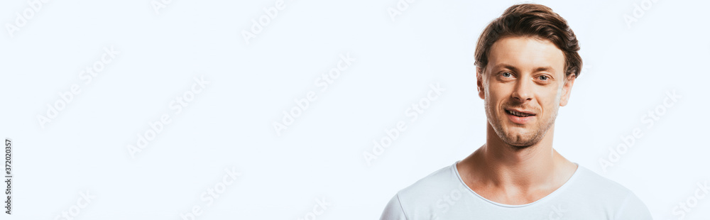 Panoramic shot of young man looking at camera isolated on white Panoramic shot of young man looking at camera isolated on white