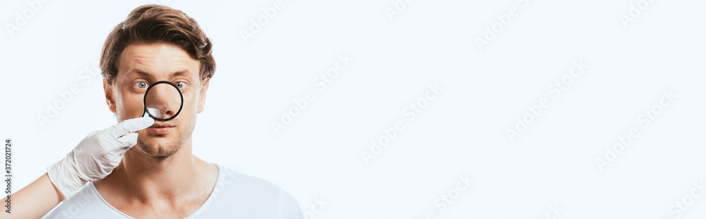 Panoramic shot of dermatologist holding loupe near nose of patient isolated on white Panoramic shot of dermatologist holding loupe near nose of patient isolated on white