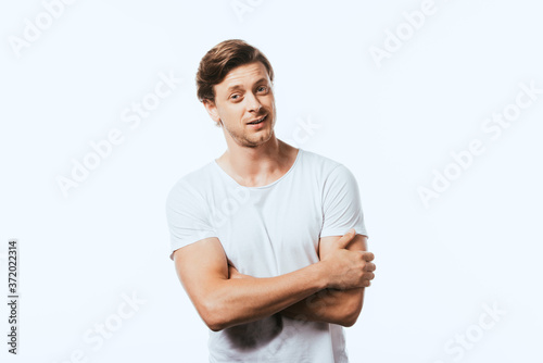 Confident man with crossed arms looking at camera isolated on white
