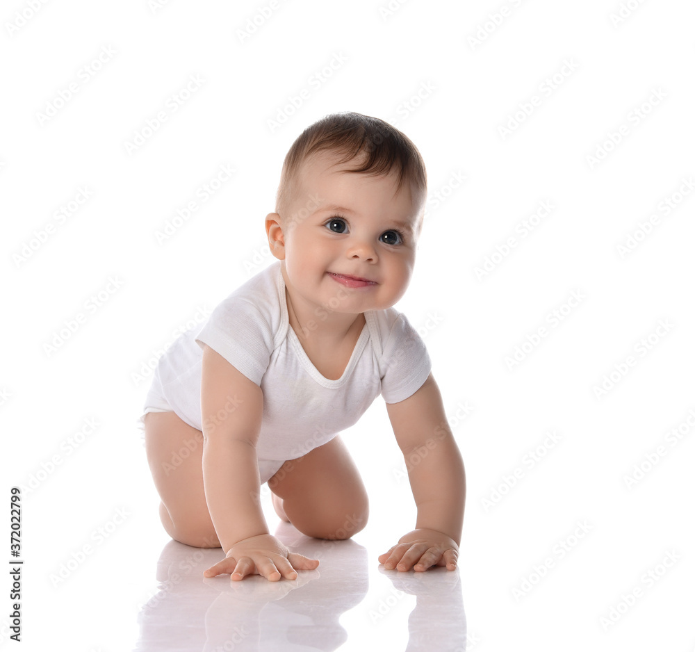 Smiling curious toddler baby in diaper and white bodysuit is crawling on floor going to get something Smiling curious toddler baby in diaper and white bodysuit is crawling on floor going to get something