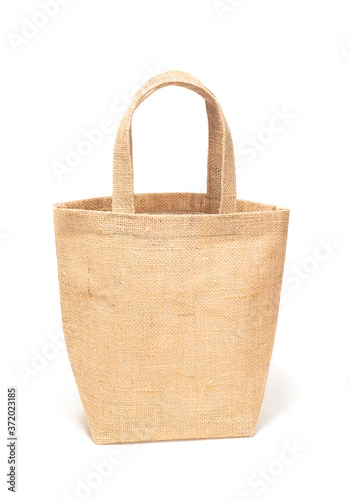 Brown handbag made from natural burlap or cotton fibre is woven isolated on white background