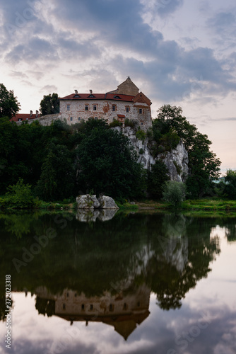 Picturesque Tyniec near Krakow, Poland. Benedictine Abbey, Monastery and Church on the Cliff . Clouds Reflection in Vistula River at Sunrise