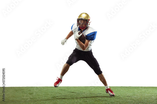 In action. American football player isolated on white studio background with copyspace. Professional sportsman during game playing in action and motion. Concept of sport, movement, achievements. © master1305