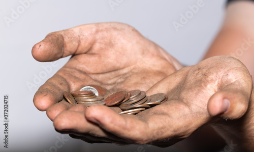 Hard Working Dirty Hands Holding Small Amount of US Change