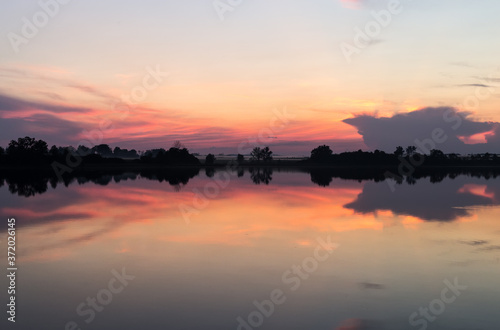 Sunset horizon mirrored in a lake