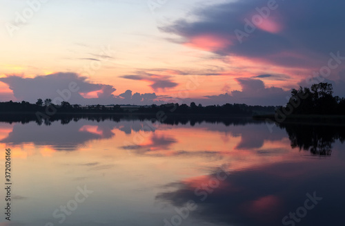 Sunset summer horizon mirrored in a lake