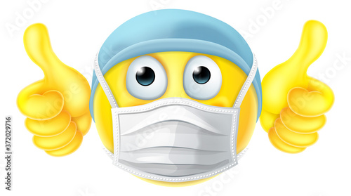 An emoticon emoji cartoon face doctor or nurse icon wearing PPE medical mask and giving thumbs up