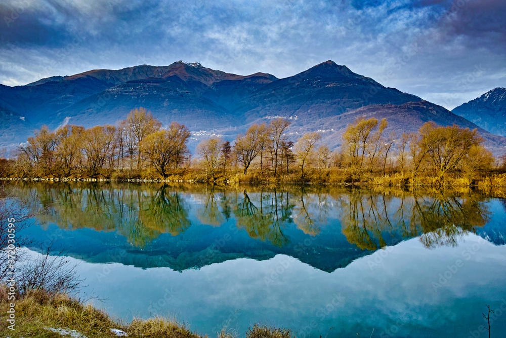 Winter panorama of the Adda river along the Valtellina path in Colico Italy