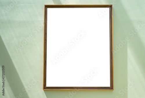 Blank frame hanging on the green wall.