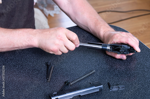 Cleaning the barrel of the pistol. Weapon care.