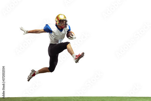 In jump, flight. American football player isolated on white studio background with copyspace. Professional sportsman during game playing in action and motion. Concept of sport, movement, achievements. © master1305