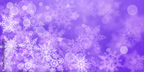 Christmas background of blurry snowflakes in purple colors