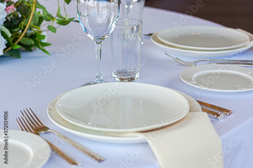 Wallpaper Mural A white plate lies on the table with a white tablecloth on a solemn day Torontodigital.ca