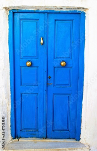Greece  Tinos island  traditional wooden door in blue color at Isternia village.