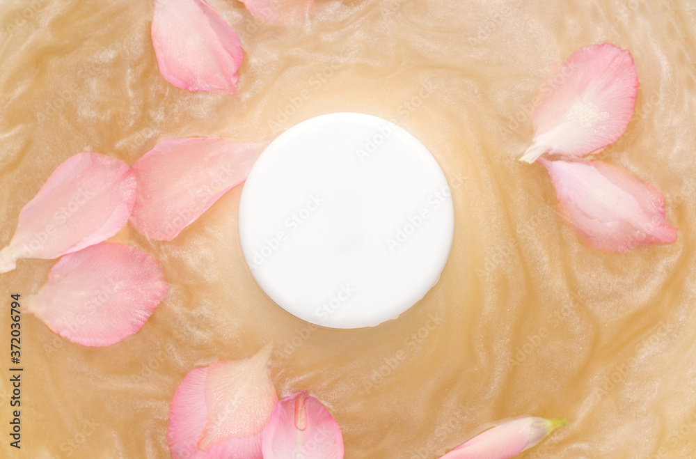 Mockup of cosmetic products. White round jar on water with shimmer and flower petals Mockup of cosmetic products. White round jar on water with shimmer and flower petals