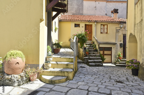 A narrow street among the old houses of Aieta, a rural village in the Calabria region. photo