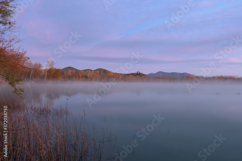 sunrise over the lake, a foggy autumn morning