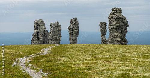 Manpupuner rock formations. Weathered stone pillars. Famous nature landmark of Ural mountains, Komi Republic, Russia. Travel destination landscape.
