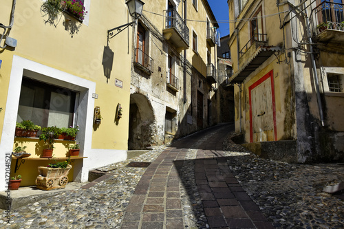 Fototapeta Naklejka Na Ścianę i Meble -  A narrow street among the old houses of Altomonte, a rural village in the Calabria region.